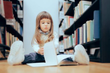 Smart Little Girl Checking a Book at the Library