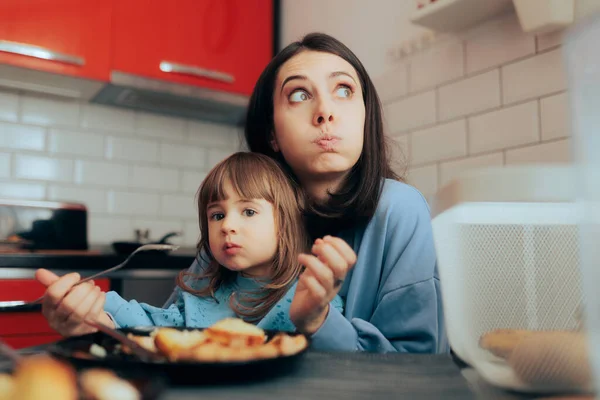 Tired Mom Trying Feed Her Toddler Daughter Kitchen — Stok fotoğraf