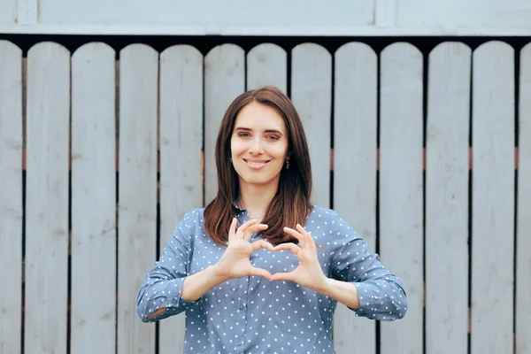 Friendly Woman Making a Heart Gesture with Her Hands