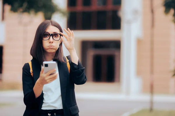 Stressed Businesswoman Checking Smartphone Outside Office Building