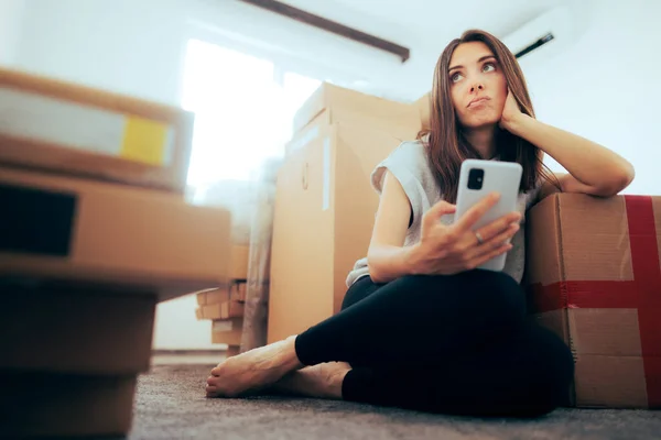 Unhappy Woman Checking Phone Surrounded Cardboard Boxed — Stock fotografie