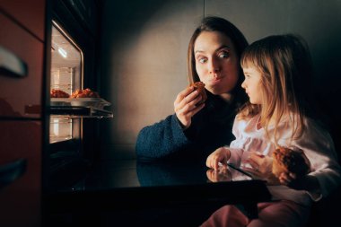 Happy Mom and Child Sharing Homemade Cupcakes