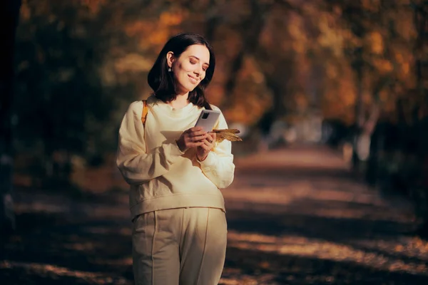 Happy Casual Woman Walking Park Checking Her Phone — Stok fotoğraf