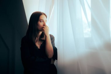 Depressed Sorrowful Woman Looking out the Window