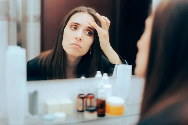 Worried Woman Checking Forehead Wrinkles Mirror — Stockfoto