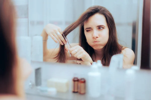 Puzzled Woman Trying Cut Her Bangs Mirror — Zdjęcie stockowe