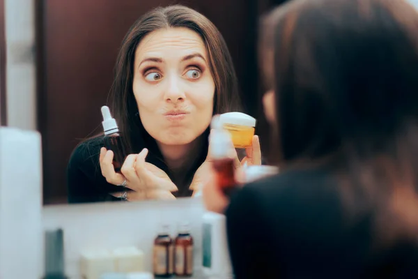 Woman Choosing Between Face Serum and Moisturizing Cream