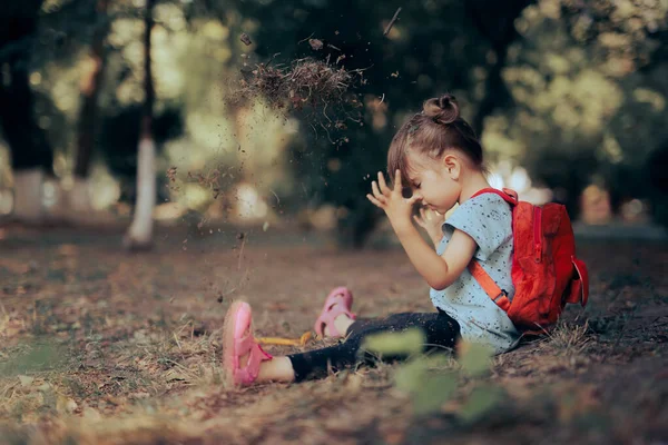 Little Girl Playing Outdoors in the Dirt Feeling Carefree