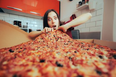 Hungry Woman Eating a Large Pizza by Herself in the Kitchen clipart