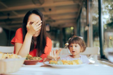 Mother Exasperated by Picky Eating Daughter in a Restaurant