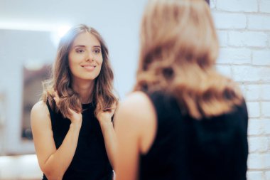 Woman Admiring Her New Look in the Mirror at a Hair Salon