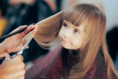 Cute Toddler Girl Getting her Hair Cute in a Professional Salon