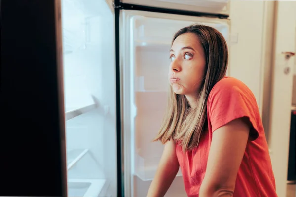 Hungry Woman Having Nothing to Eat Looking at Empty Fridge