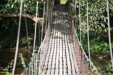 wooden hanging suspended rope bridge in garden park