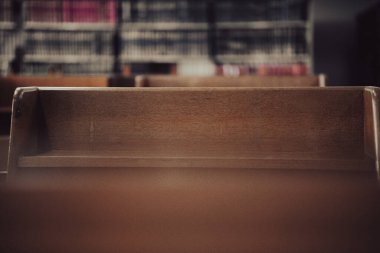 wooden table with bookshelf for reading in library interior