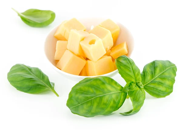 Cheese and basil leaves isolated on white background — Stock Photo, Image