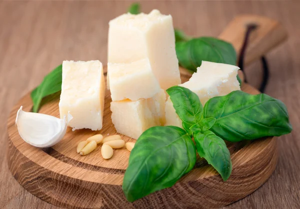 Parmesan cheese and basil leaves — Stock Photo, Image