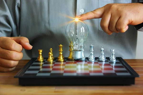 Business Man Touching Light Bulb Chess Board Golden Silver Chess — Stock Photo, Image