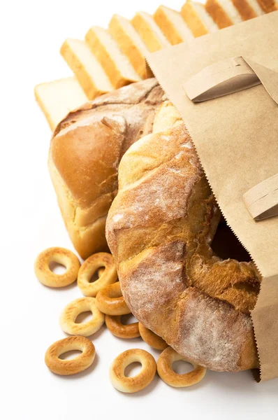 Fresh bread in paper bag on the white — Stock Photo, Image