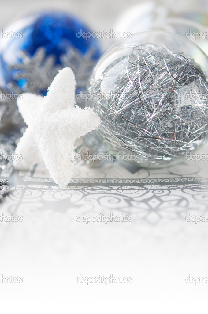 Blue and silver xmas baubles on holiday background