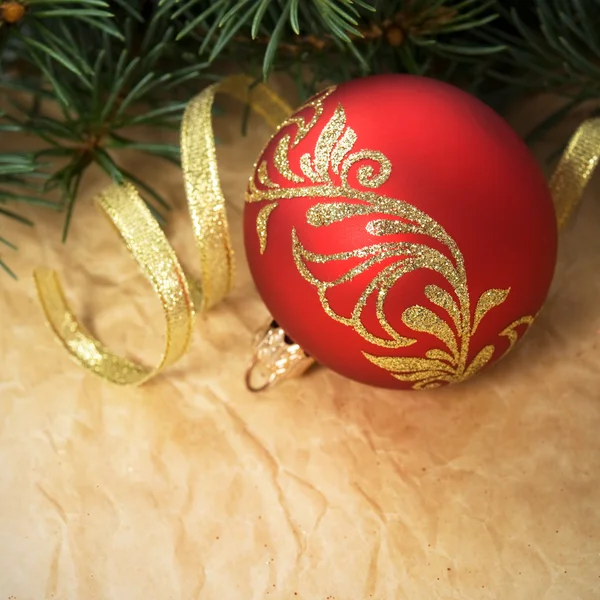 Xmas ornaments and spruce on crumpled paper background — Stock Photo, Image