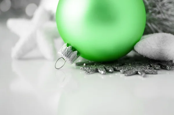 Green and silver xmas decoration on white background
