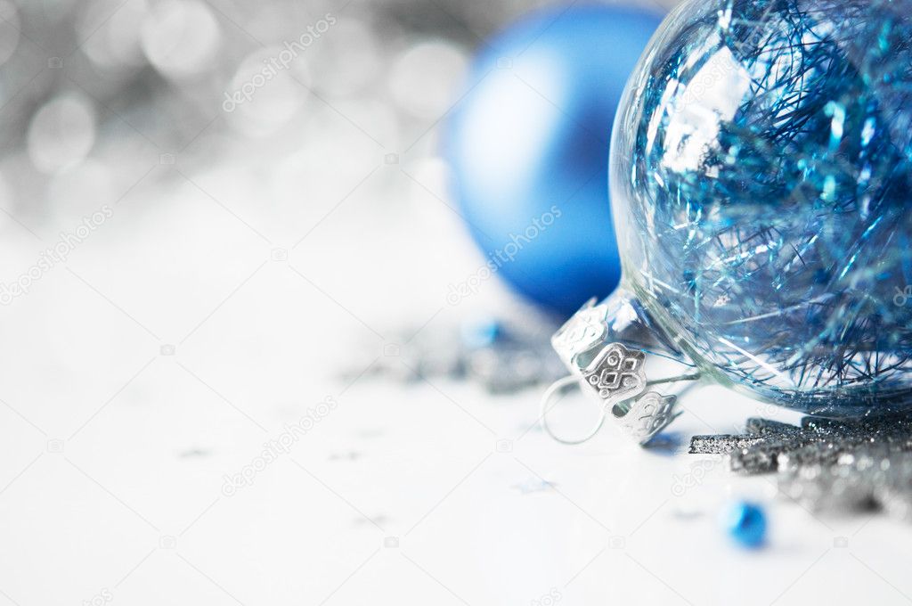 Blue and silver xmas ornaments on bright holiday background