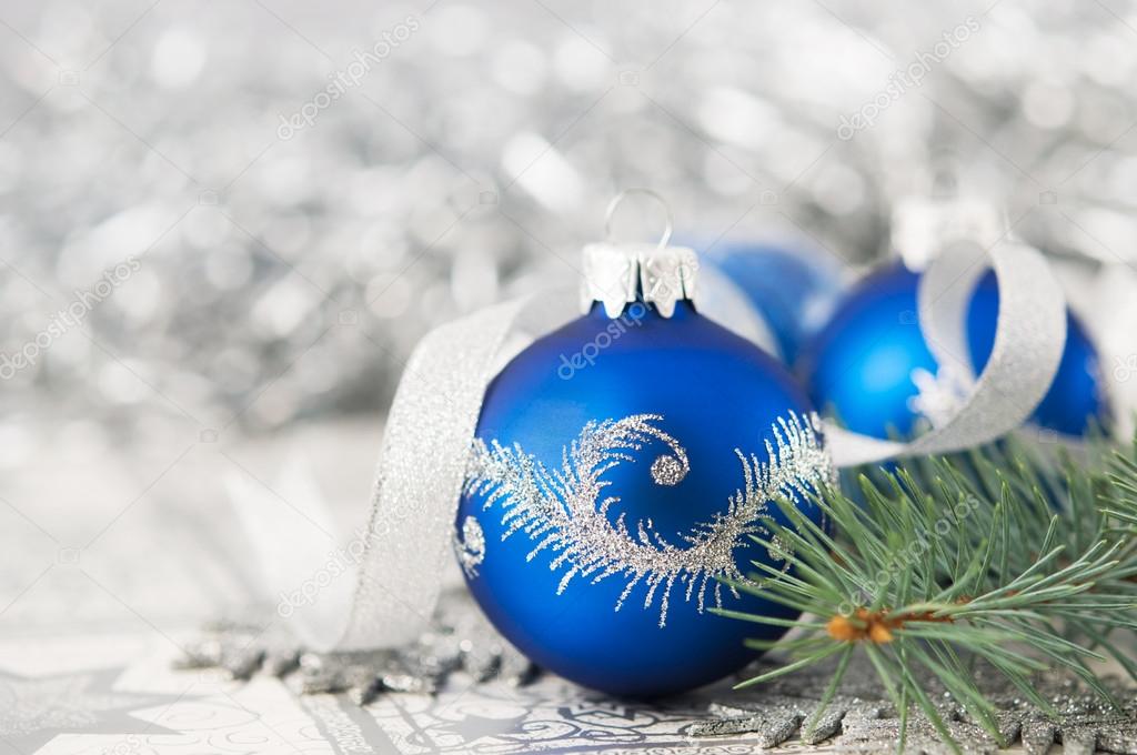 Blue and silver xmas ornaments on bright holiday background