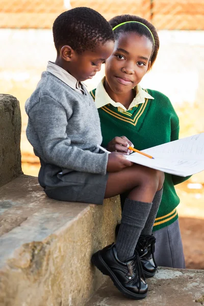 Sister teaching her little brother to read — Stock Photo, Image