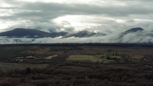 Ben Nevis mountain range surrounded by clouds at sunrise - aerial footage 4k — Stockvideo