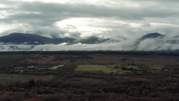 Ben Nevis mountain range surrounded by clouds at sunrise - aerial footage 4k — Wideo stockowe