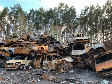Burnt and blown up car. Cars damaged after shelling. Traces of shots on the body of the car. War between Russia and Ukraine, Irpin-Bucha, April 10, 2022