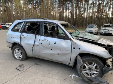 Burnt and blown up car. Cars damaged after shelling. Traces of shots on the body of the car. War between Russia and Ukraine, Irpin-Bucha, April 10, 2022