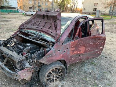 Burnt and blown up car. Cars damaged after shelling. Traces of shots on the body of the car. War between Russia and Ukraine, Irpin-Bucha, April 10, 2022