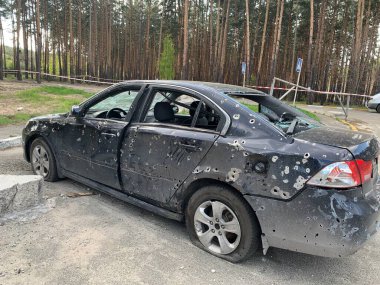Burnt and blown up car. Traces of shots on the body of the car. Cars damaged after shelling. War between Russia and Ukraine, Irpin-Bucha, April 10, 2022