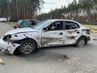 Burnt and blown up car. Traces of shots on the body of the car. Cars damaged after shelling. War between Russia and Ukraine, Irpin-Bucha, April 10, 2022