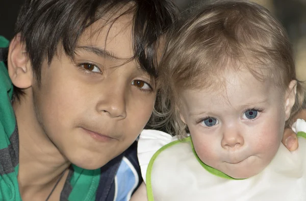 Outdoor night portrait of the baby and teenager. — Stock Photo, Image