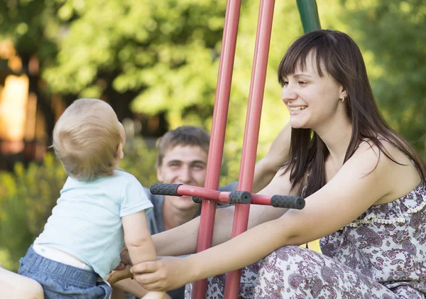 Family is walking in a playground. — Stock Photo, Image