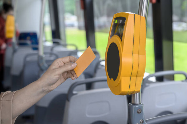 the passenger pays contactless with a bank card for public transport in the tram.