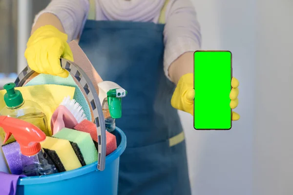 Homeowner Rubber Gloves Holding Detergent Bottles Hold Mobile Phone Blank — стоковое фото