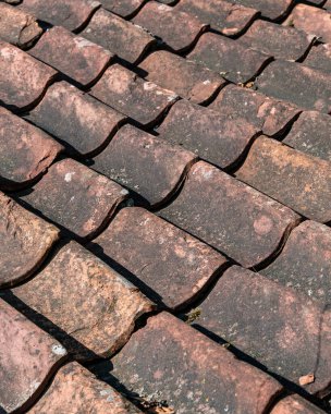 fragment of a tiled roof. Old cracked tiled roof. Texture of clay tiles