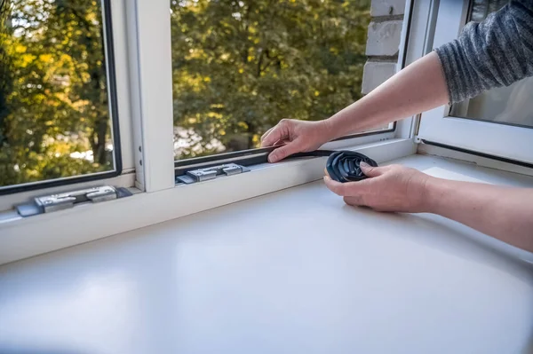 Preparing Cold Season Woman Sticks Dark Rubber Sealing Tape Window — Stock Photo, Image