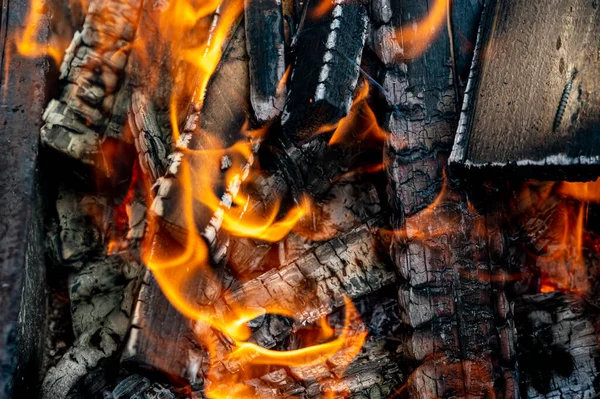 burning wood in a fireplace. Close-up. Kindling firewood for barbecue.