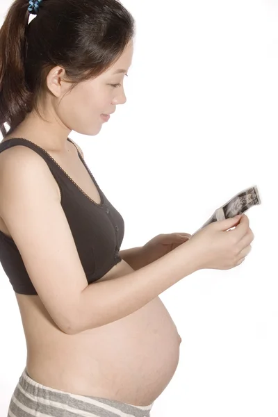 Pretty young pregnant woman looking at her baby's B ultrasonic — Stock Photo, Image