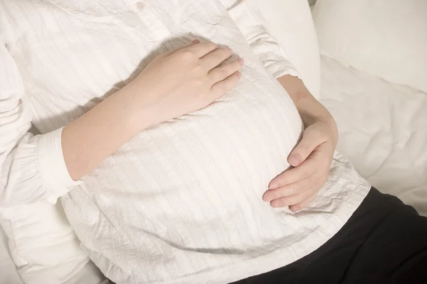 Pretty young pregnant woman touch her belly — Stock Photo, Image