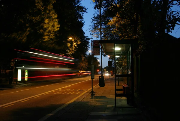 A motion blurred photograph of a red London double decker bus — Stock Photo, Image