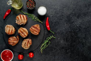 Sebzeli ızgara et ve siyah arka planda baharat. Üst Manzara. Metnin için boş yer.