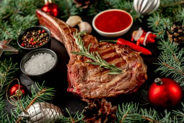 Biberiyeli ızgara biftek ve ahşap masada baharatlar.