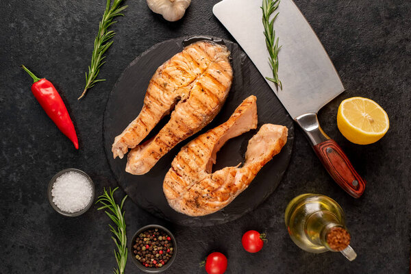 grilled salmon fillet with lemon and rosemary. top view. free space for your text.