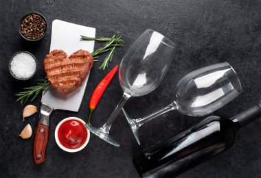 grilled meat and wine on a black background. top view. free space for your text.